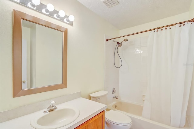 full bathroom featuring toilet, shower / tub combo, vanity, and a textured ceiling