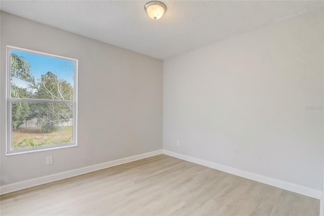 unfurnished room with plenty of natural light and light hardwood / wood-style floors