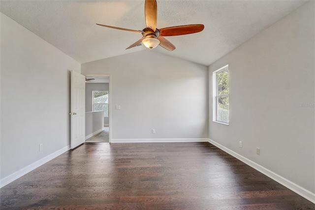 spare room with ceiling fan, plenty of natural light, dark hardwood / wood-style flooring, and lofted ceiling