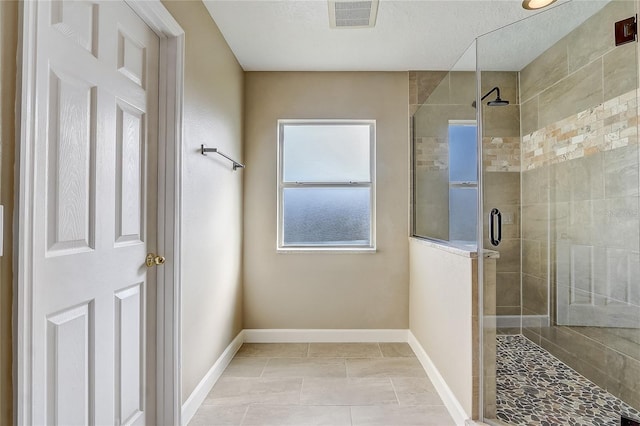 bathroom featuring tile patterned floors and a shower with door