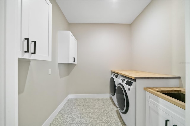 laundry room with cabinets and separate washer and dryer