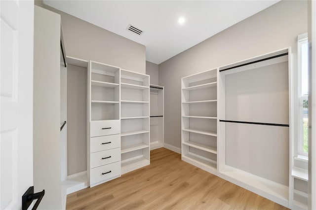 walk in closet featuring light hardwood / wood-style floors