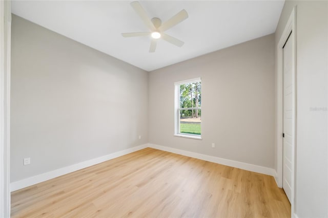 unfurnished bedroom featuring light wood-type flooring, ceiling fan, and a closet