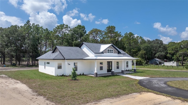 view of front of home featuring a front lawn and a porch