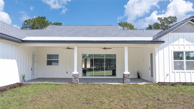 rear view of property featuring ceiling fan, a lawn, and a patio