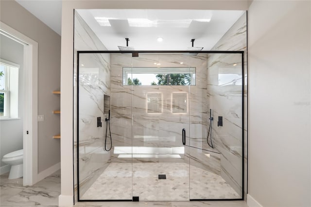 bathroom with marble finish floor, a marble finish shower, and baseboards