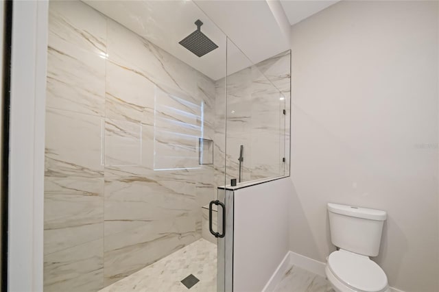 full bath with marble finish floor, a marble finish shower, toilet, and baseboards