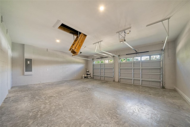 garage featuring electric panel and a garage door opener