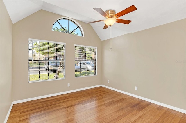 spare room with ceiling fan, light hardwood / wood-style flooring, and vaulted ceiling