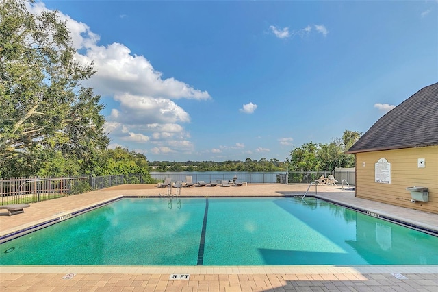 pool featuring fence and a patio