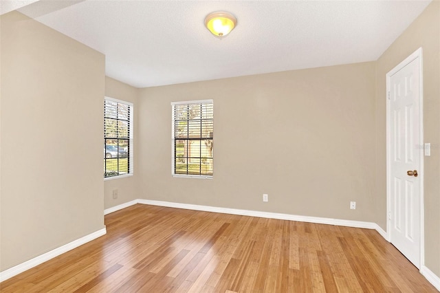 unfurnished room featuring light wood-style floors and baseboards