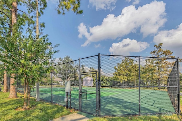 view of sport court featuring fence and a gate