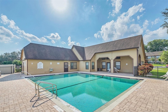 community pool featuring a patio area and fence