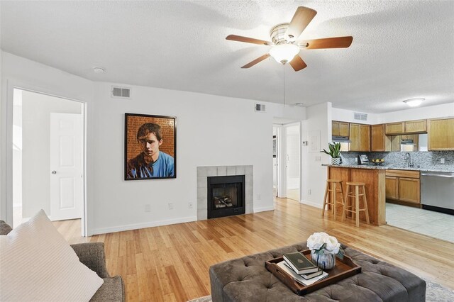 living area with light wood-style flooring and visible vents