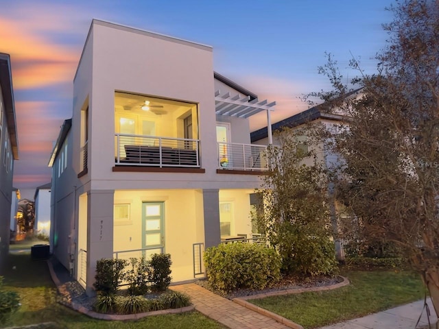 modern home with a balcony and a yard