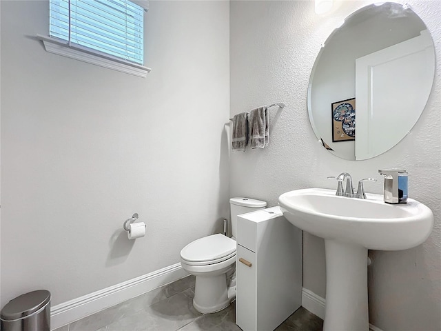 bathroom featuring tile patterned flooring and toilet