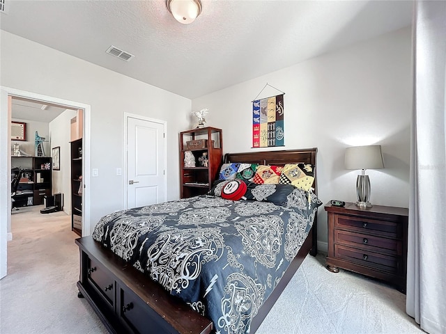 carpeted bedroom featuring a textured ceiling