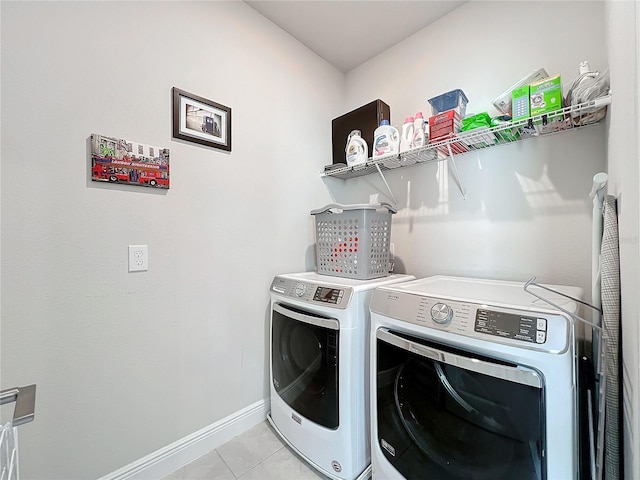 clothes washing area with separate washer and dryer and light tile patterned floors