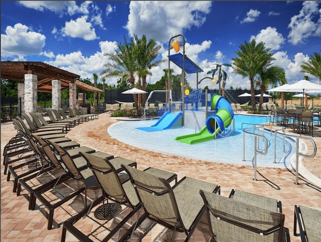 view of jungle gym with a community pool and a patio