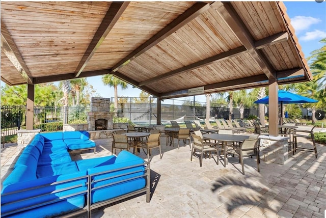 view of patio / terrace with a gazebo and an outdoor living space with a fireplace