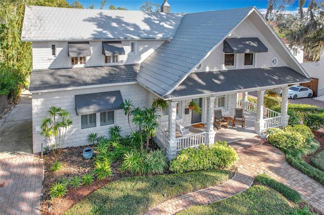 back of house featuring a porch