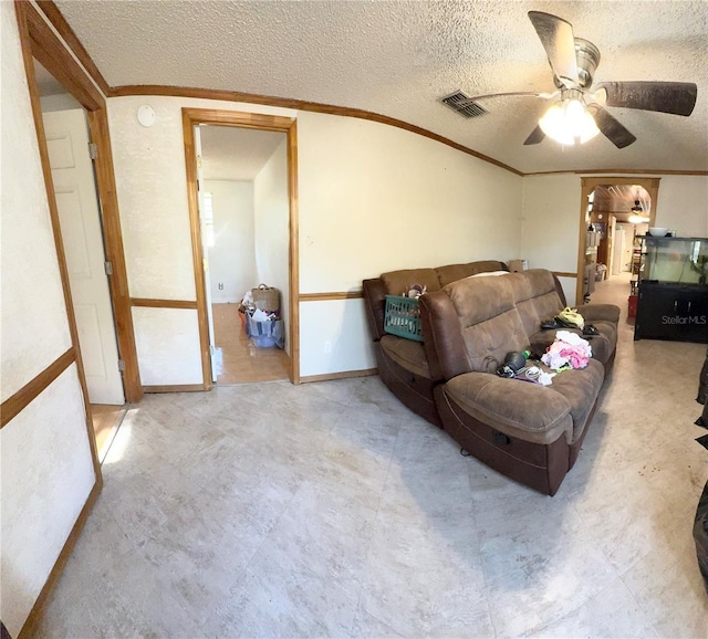 living room featuring a textured ceiling and ceiling fan