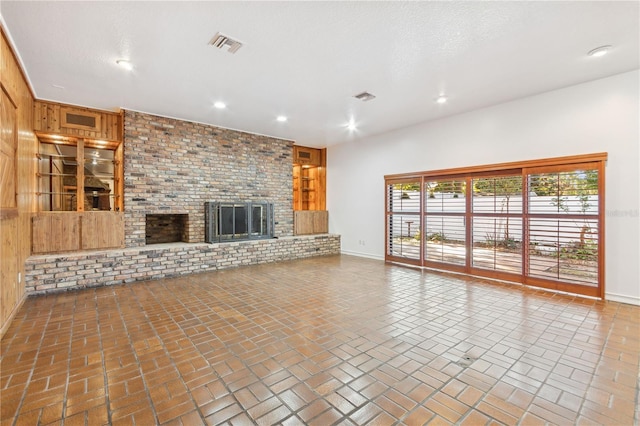 unfurnished living room with a fireplace and a textured ceiling