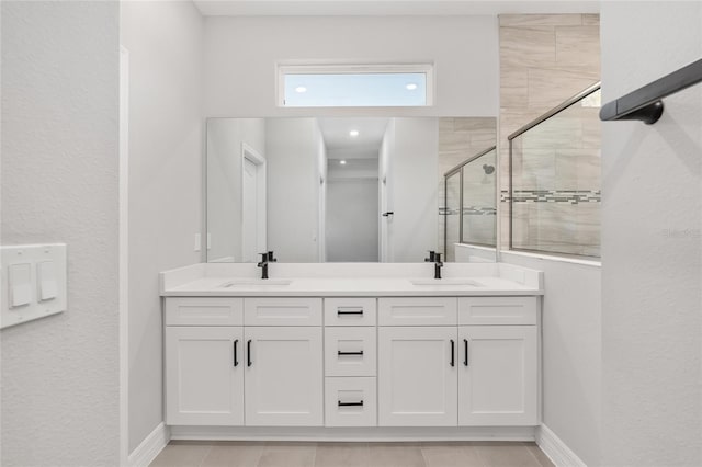 bathroom featuring vanity and a shower with shower door