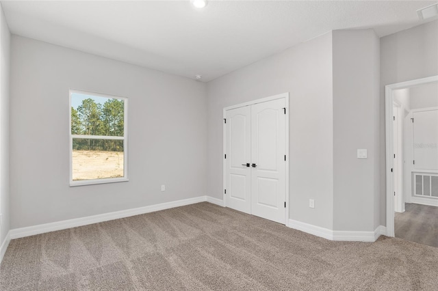 unfurnished bedroom with a closet and carpet