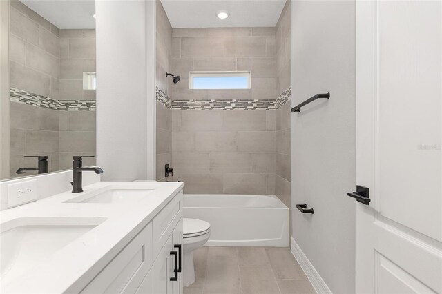 full bathroom featuring toilet, vanity, and tiled shower / bath