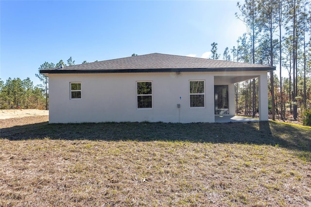 rear view of property featuring a yard