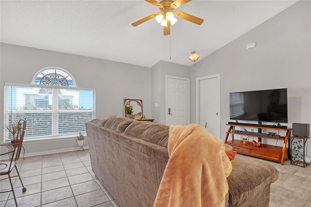 tiled living room featuring lofted ceiling and ceiling fan