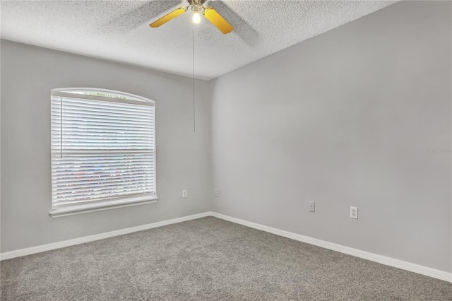 carpeted spare room featuring a textured ceiling and ceiling fan