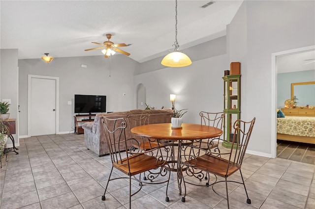 dining area with lofted ceiling, ceiling fan, and light tile patterned flooring