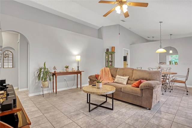 tiled living room with lofted ceiling and ceiling fan