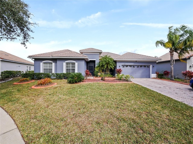 view of front of house with a front yard and a garage