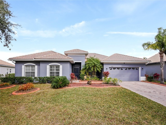 mediterranean / spanish-style house with a front lawn and a garage