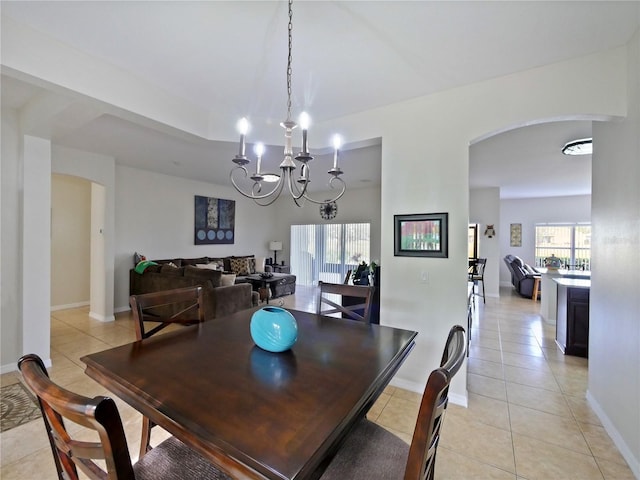 dining room featuring light tile patterned flooring and a chandelier