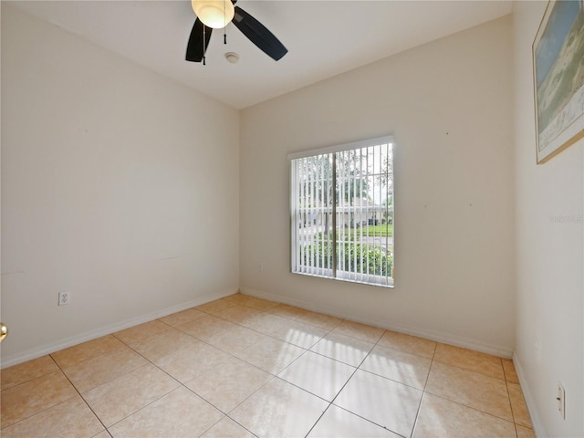 tiled empty room with ceiling fan