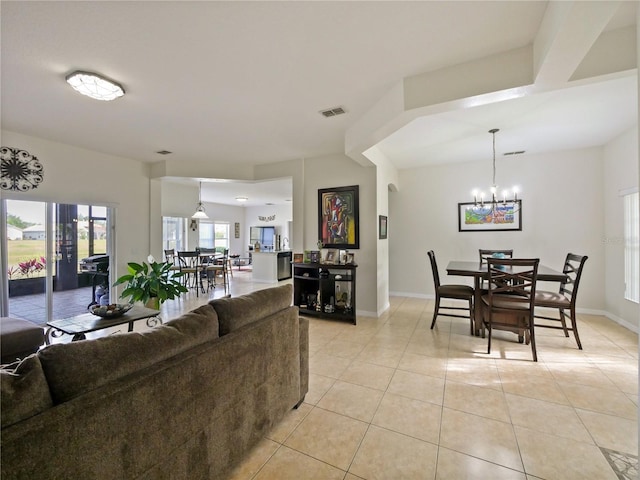 living room with light tile patterned flooring and a chandelier