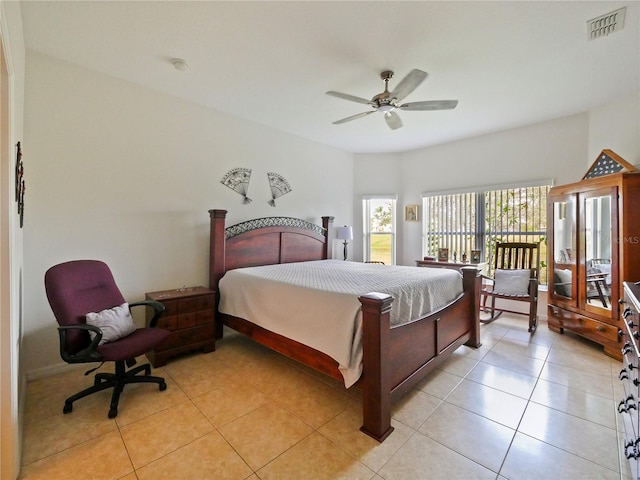 tiled bedroom featuring ceiling fan