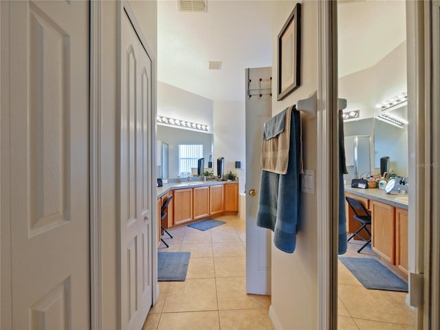 bathroom with tile patterned flooring and vanity