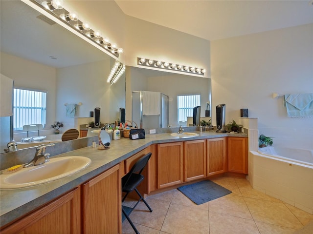 bathroom with independent shower and bath, vanity, and tile patterned floors