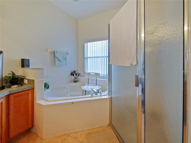 bathroom with shower with separate bathtub and tile patterned floors