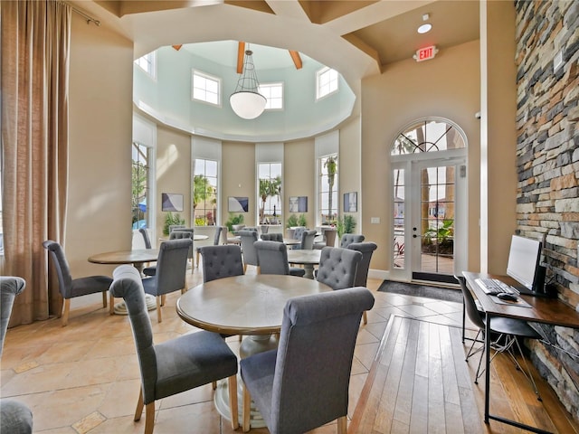 dining room with a towering ceiling