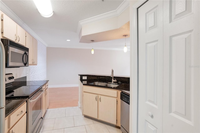 kitchen with decorative light fixtures, light tile patterned floors, appliances with stainless steel finishes, ornamental molding, and sink