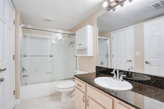 full bathroom with toilet, a textured ceiling, shower / bath combination with glass door, tile patterned floors, and vanity