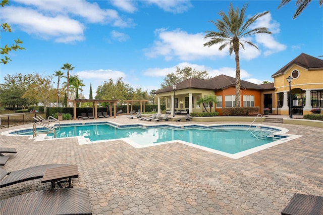 view of swimming pool featuring a pergola and a patio