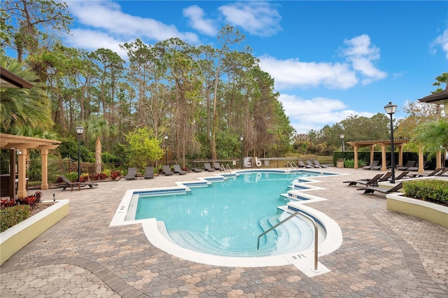 view of pool featuring a pergola and a patio