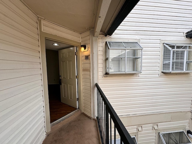 view of exterior entry with a balcony